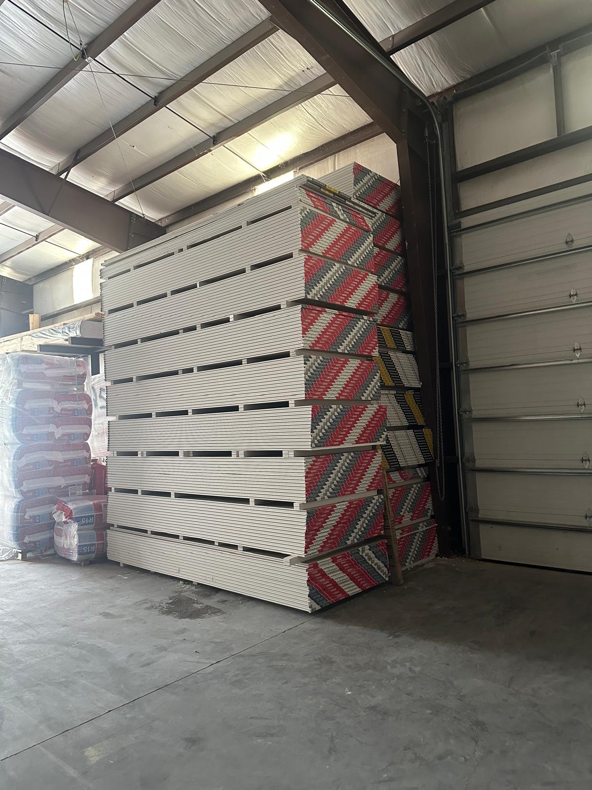 Stacks of Sheetrock drywall panels in the A&P Supply warehouse